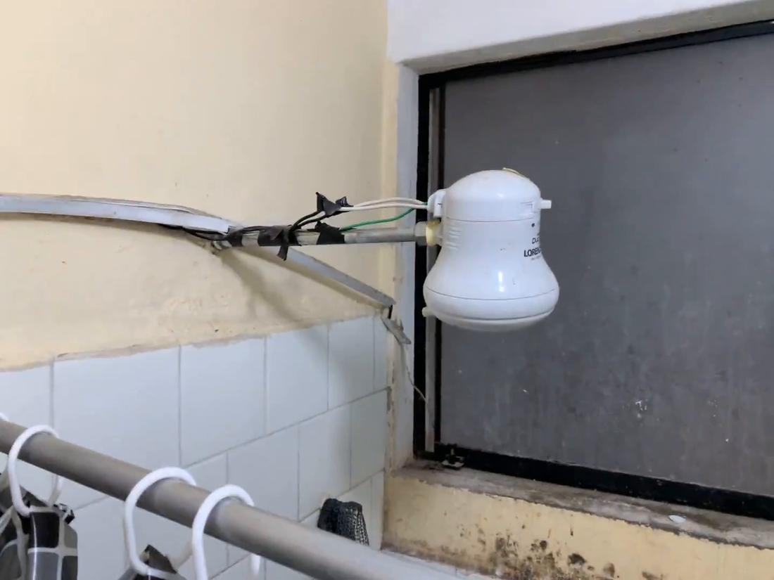 Before: an electric shower heater hanging from exposed wiring